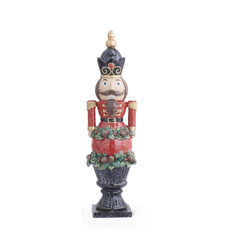 Resin glittered nutcracker in a red uniform on a black pedestal base.