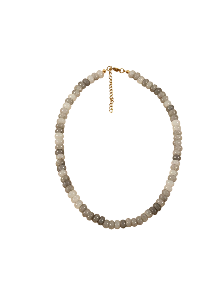 Glass beaded necklace with round grey and white beads and a gold-toned lobster clasp and chain.