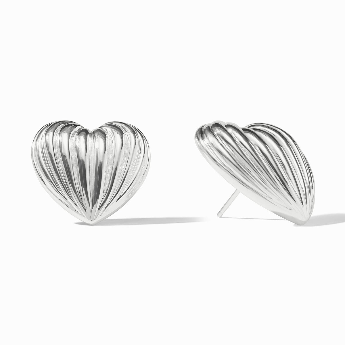 Pair of silver puffy heart statement stud earrings with a ribbed texture on a white background.