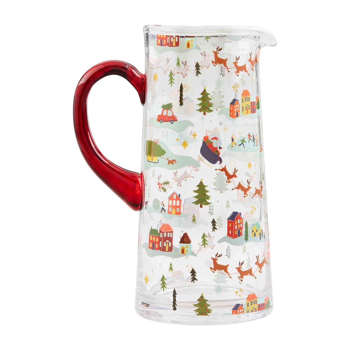 Glass Christmas village-themed pitcher with festive holiday scene illustration.