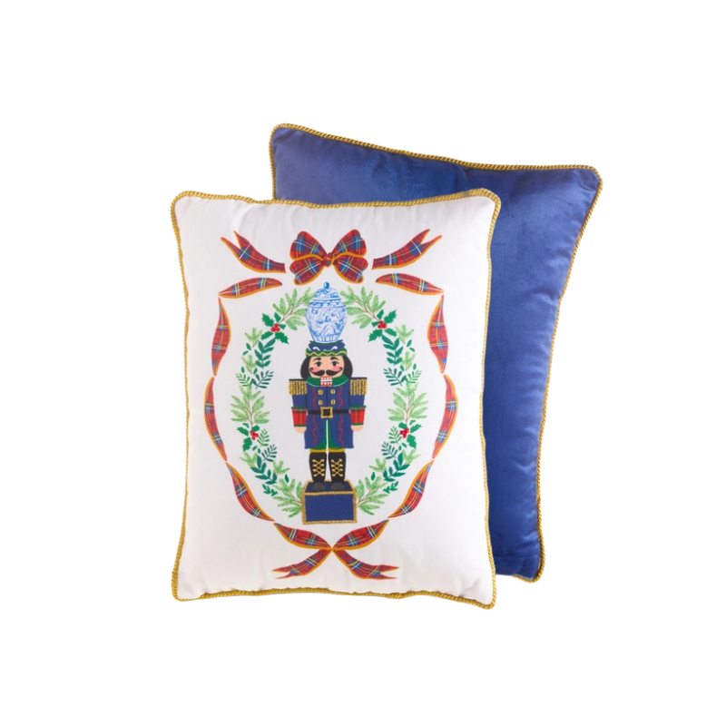 16-inch Noble Nutcracker pillow with a white front, embroidered nutcracker, and blue velvet back.