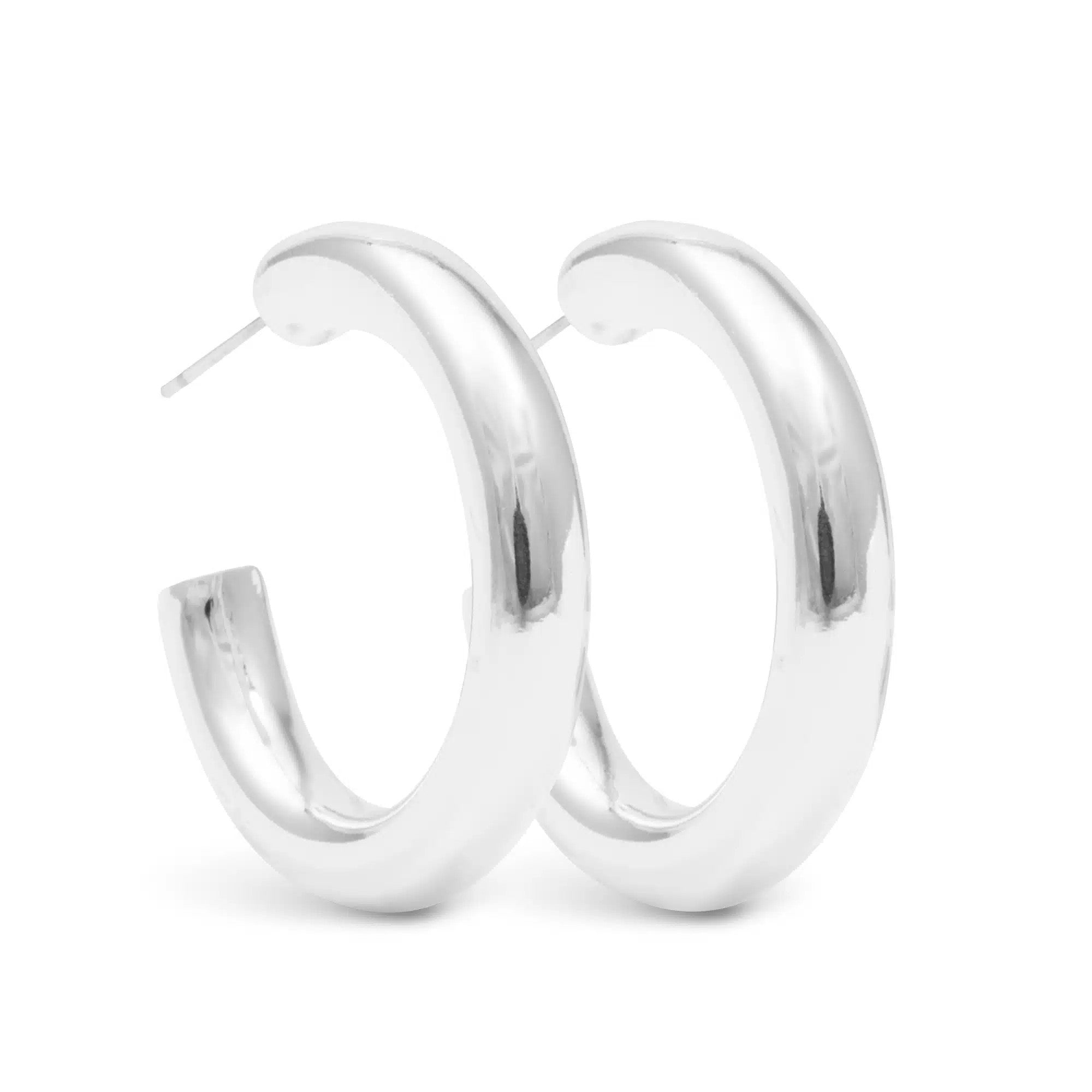 Pair of thick, polished silver Savannah hoop earrings with a smooth, reflective finish.