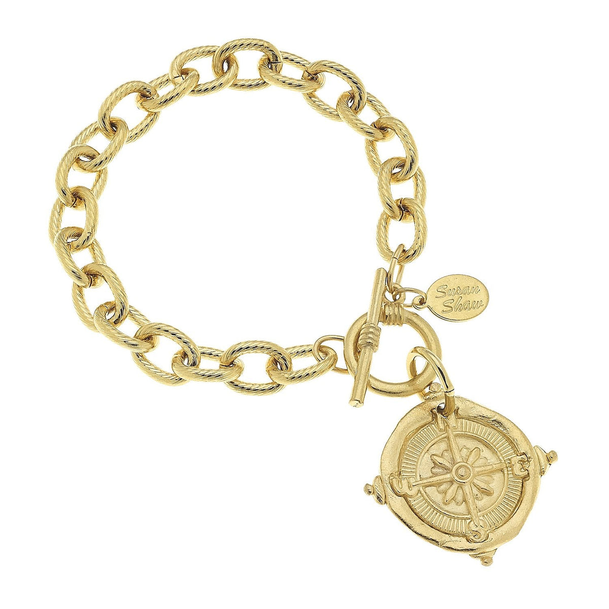Gold compass toggle bracelet with a textured link chain and a round compass charm.