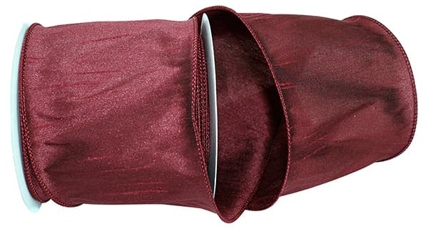 4 inch burgundy Dupioni Supreme wired edge ribbon on a spool.