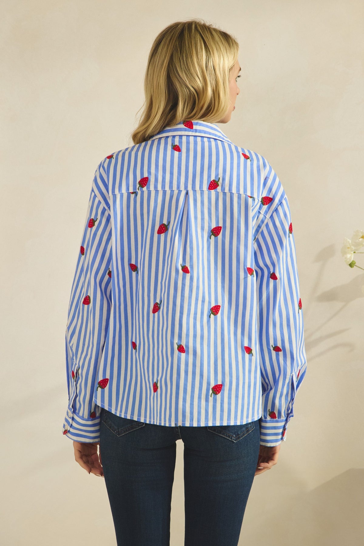 Eleanor button-down blouse in white cotton with red strawberry embroidery on the chest.