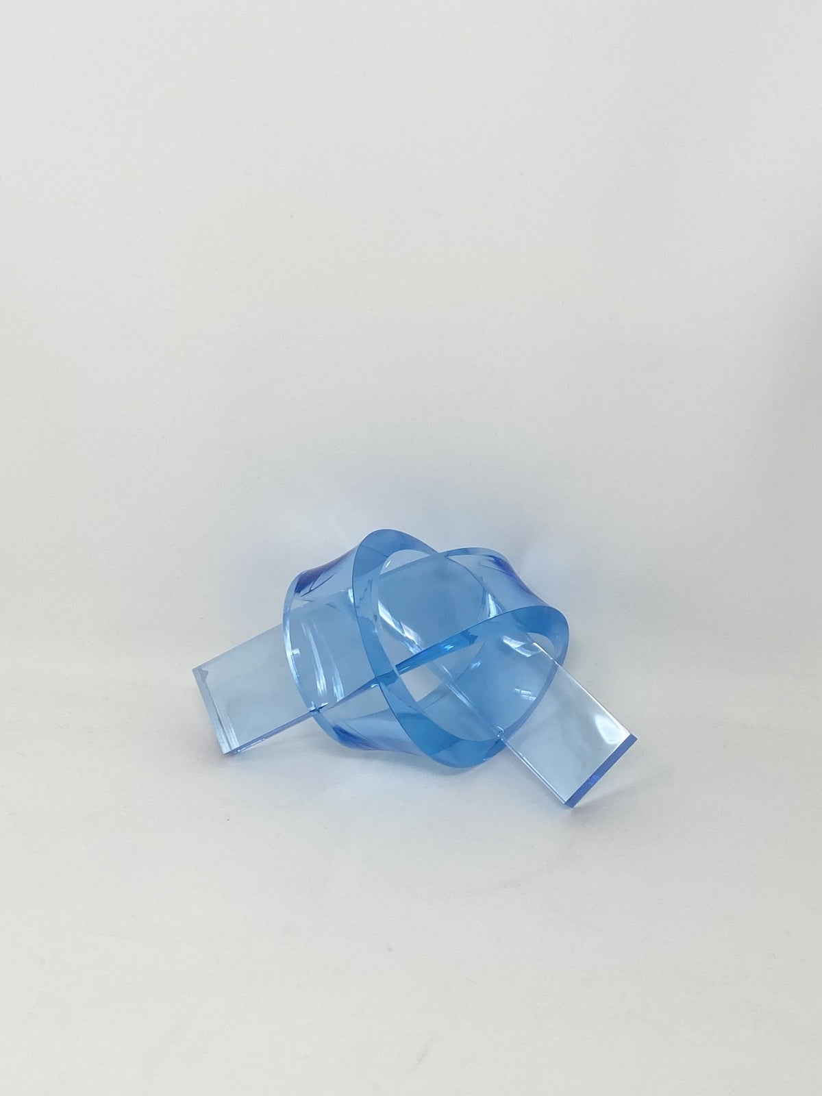 Acrylic knot pendant in clear acrylic with a silver-tone bail.