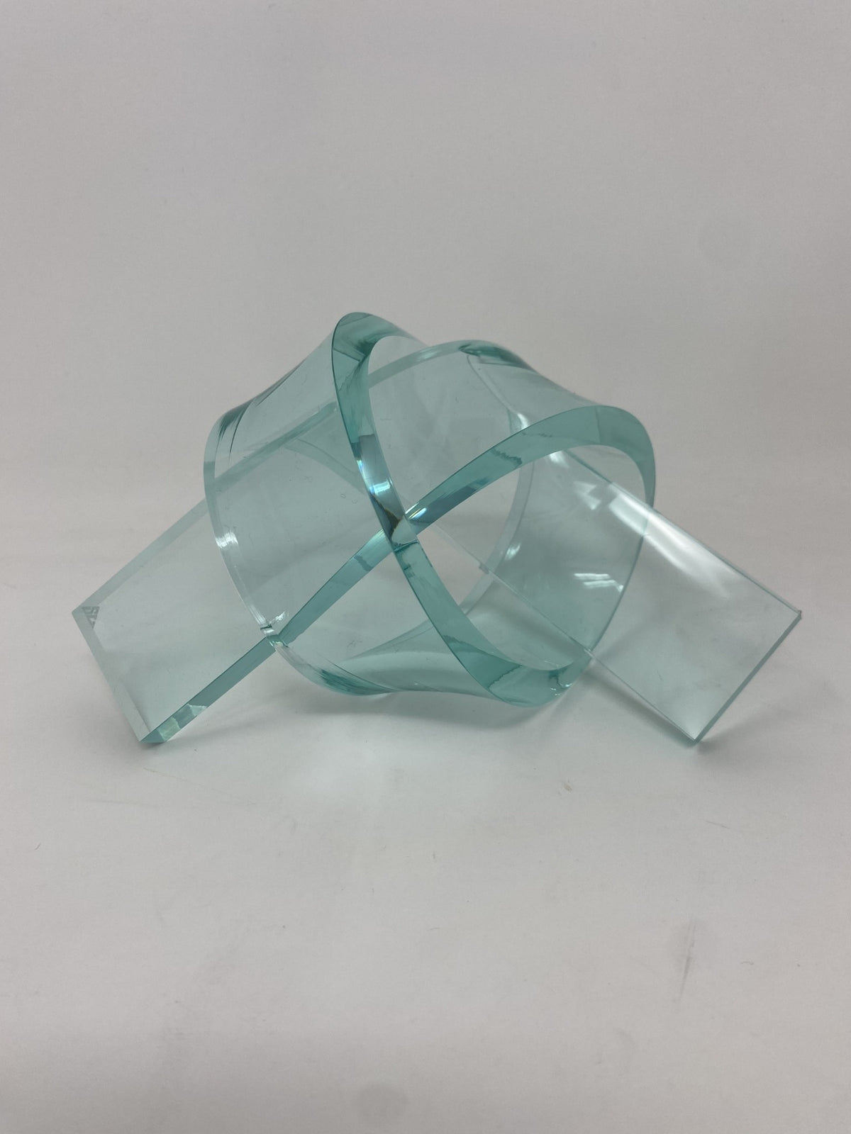 Acrylic knot pendant in clear acrylic with a black cord chain.