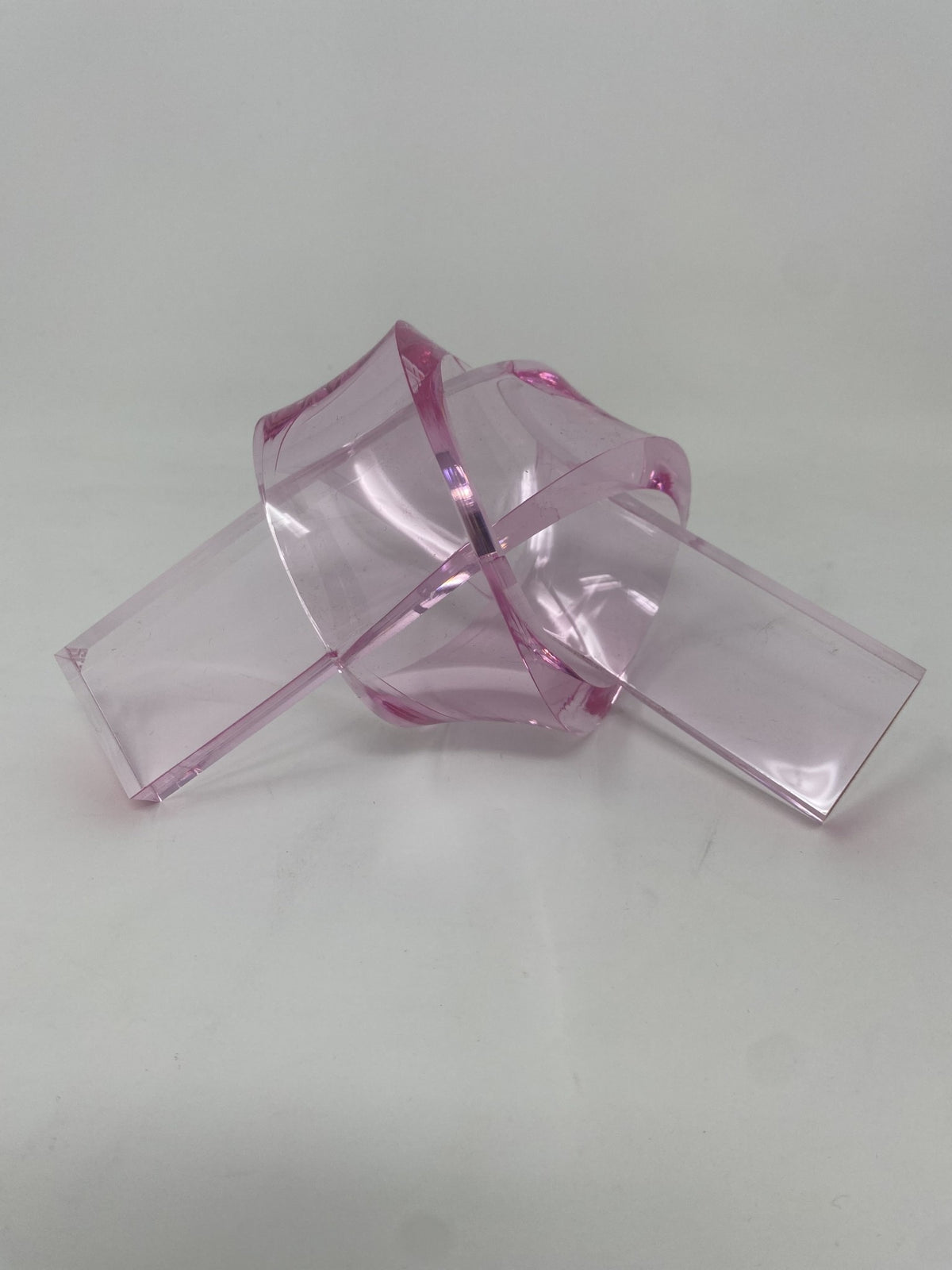 Acrylic knot pendant in clear acrylic with a silver-toned bail.