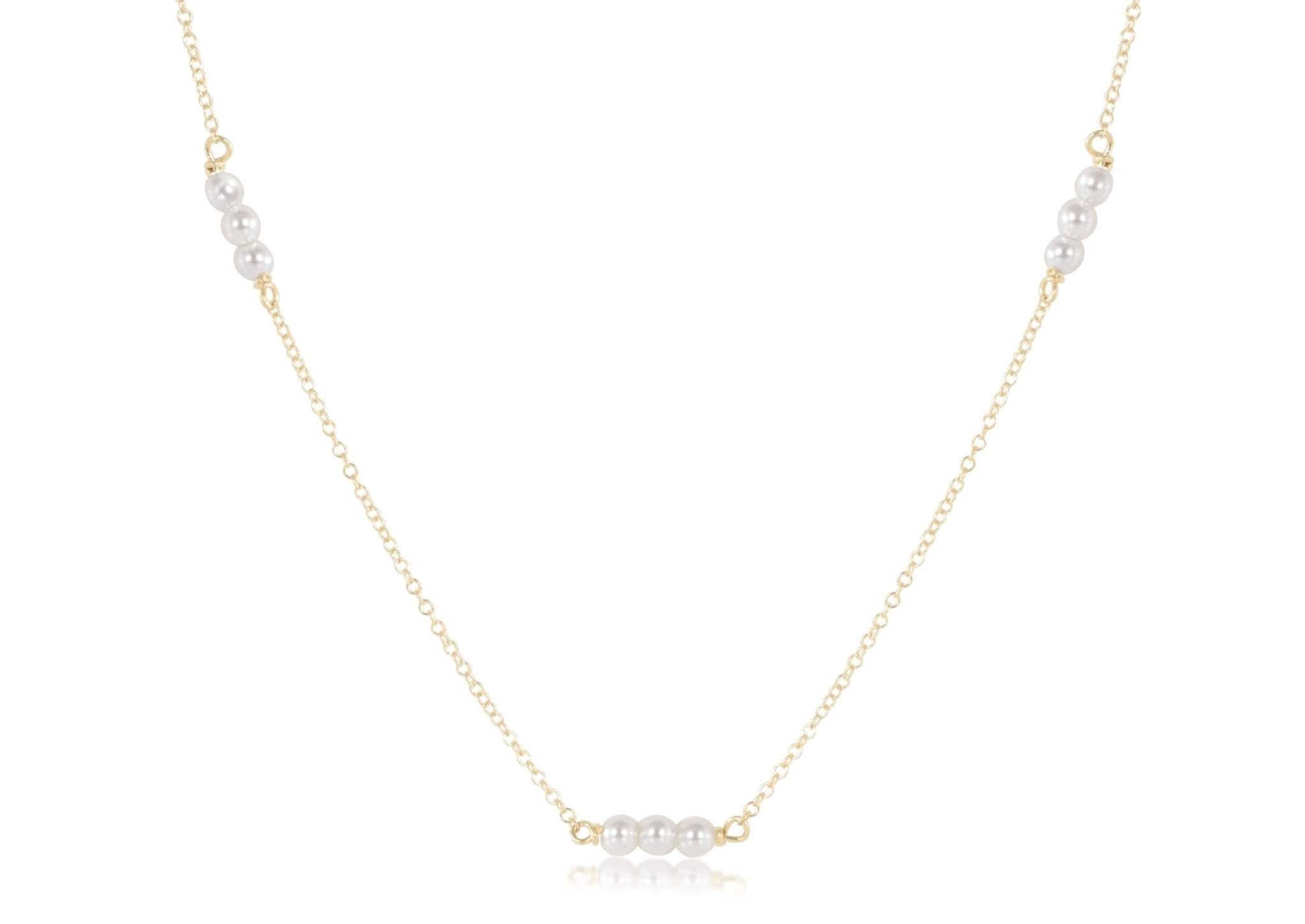 Gold-filled choker necklace featuring a delicate chain with three millimeter pearls.