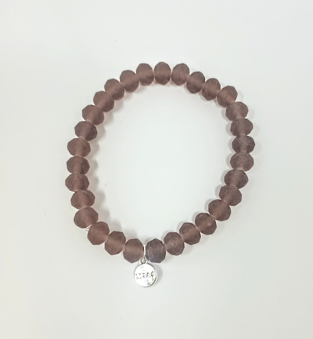 Stretchy bracelet with faceted glass beads in assorted colors.