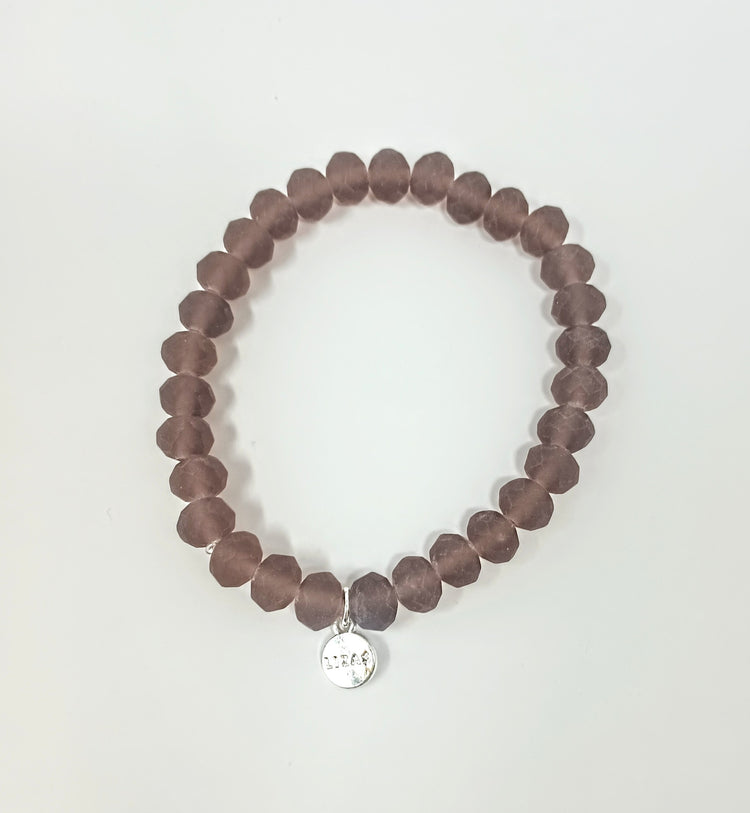 Stretchy bracelet with faceted glass beads in assorted colors.