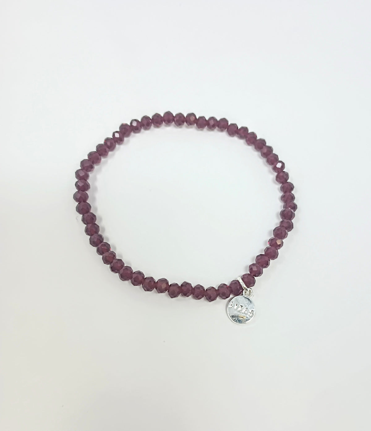Stretchy bracelet with faceted glass beads in a colorful beaded pattern.