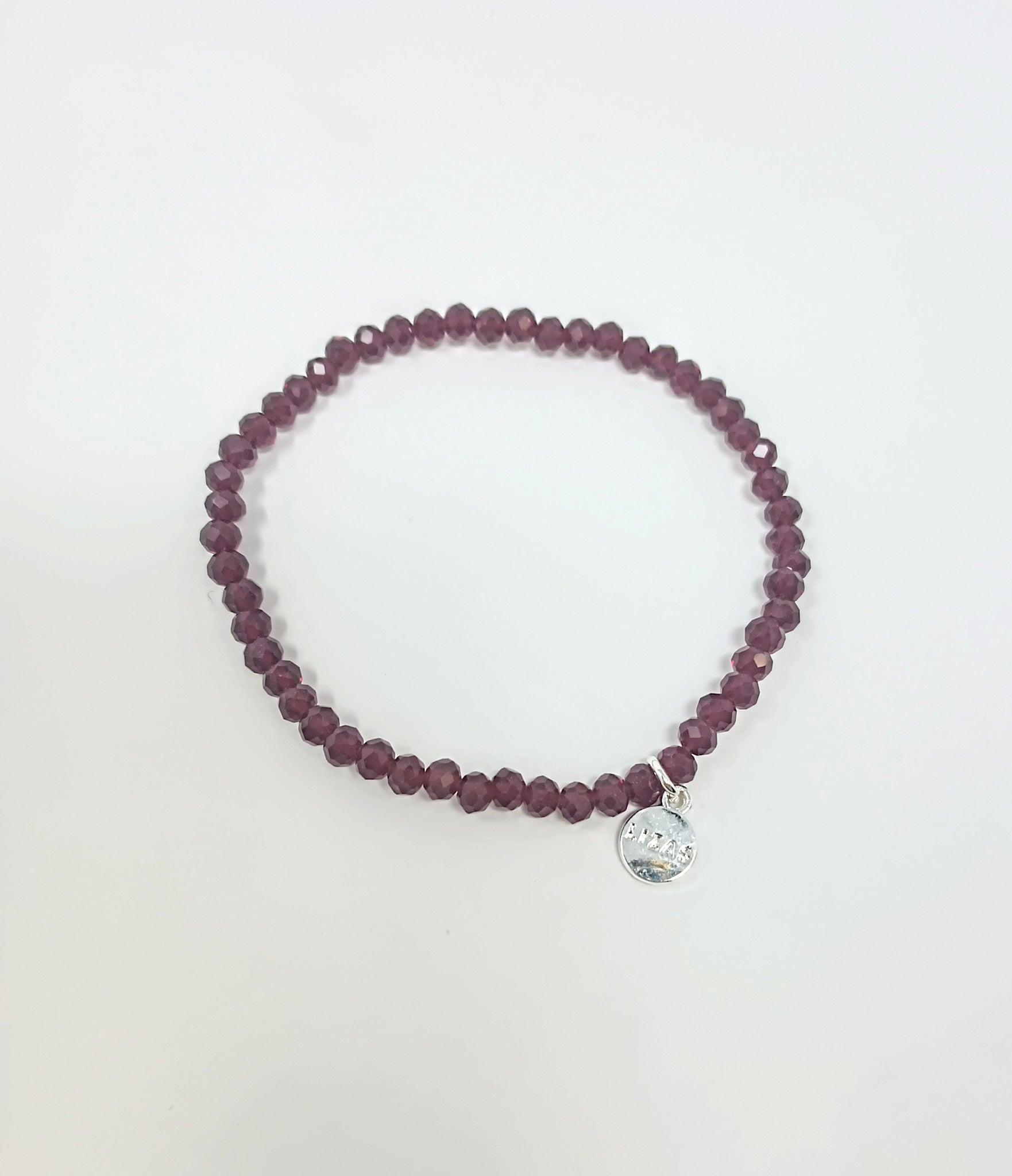 Stretchy bracelet with faceted glass beads in a colorful beaded pattern.