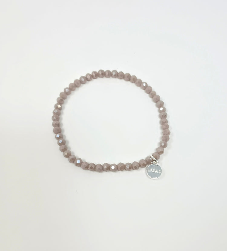 Stretchy bracelet with faceted glass beads in mixed colors on a white background.