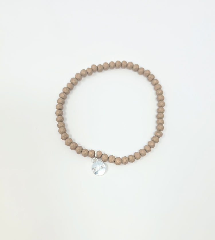 Stretchy bracelet with faceted glass beads in a colorful beaded pattern.