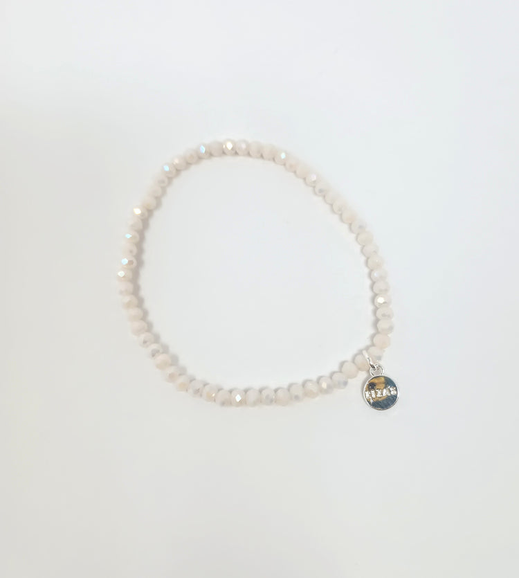 Stretchy beaded bracelet with faceted glass beads in a colorful pattern.