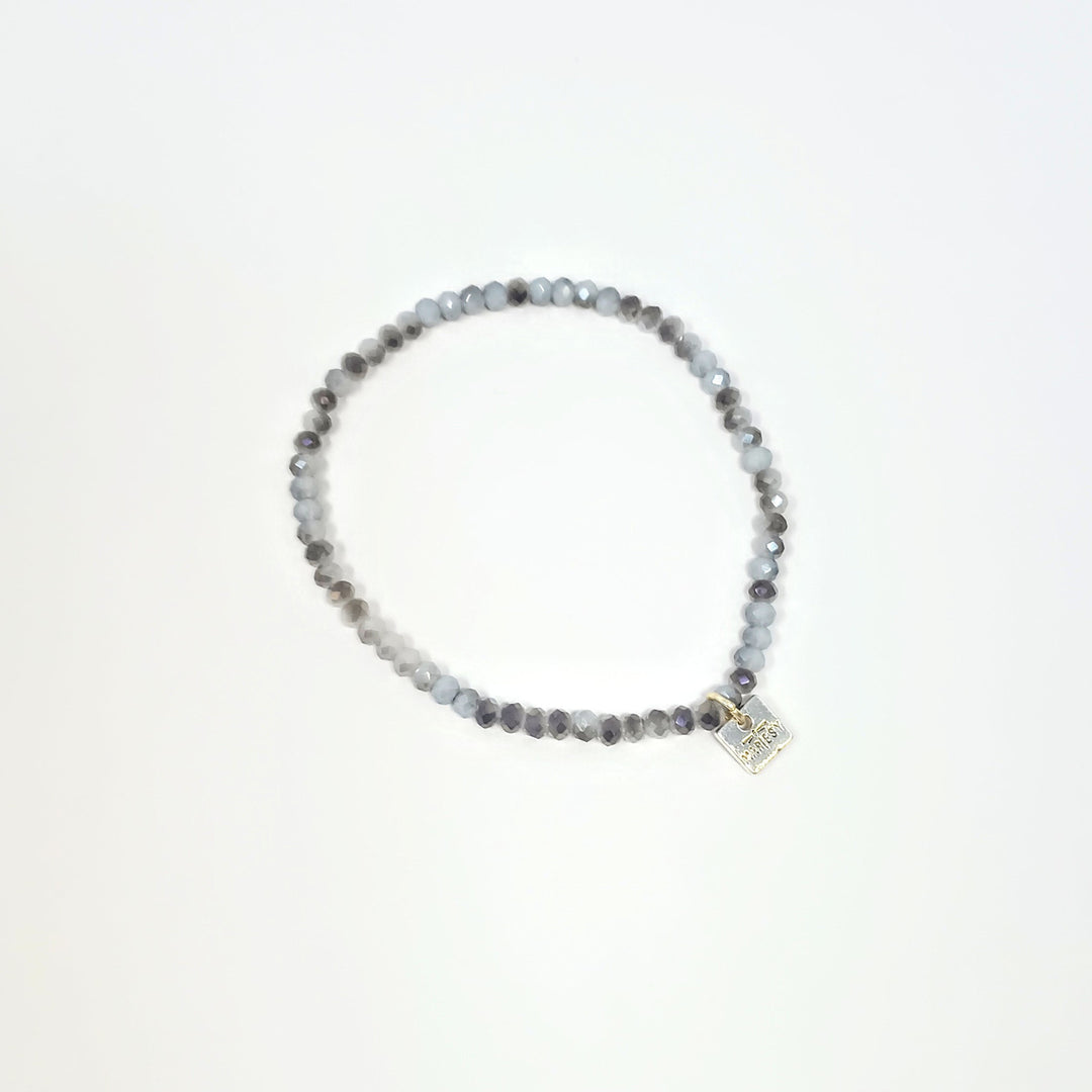 Stretchy bracelet with faceted glass beads in a colorful beaded pattern.