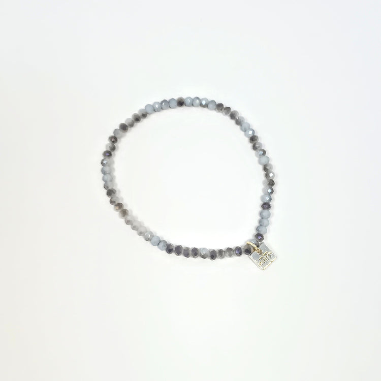 Stretchy bracelet with faceted glass beads in a colorful beaded pattern.