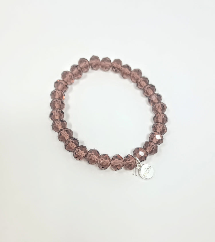Stretchy bracelet with faceted glass beads in a colorful beaded pattern.