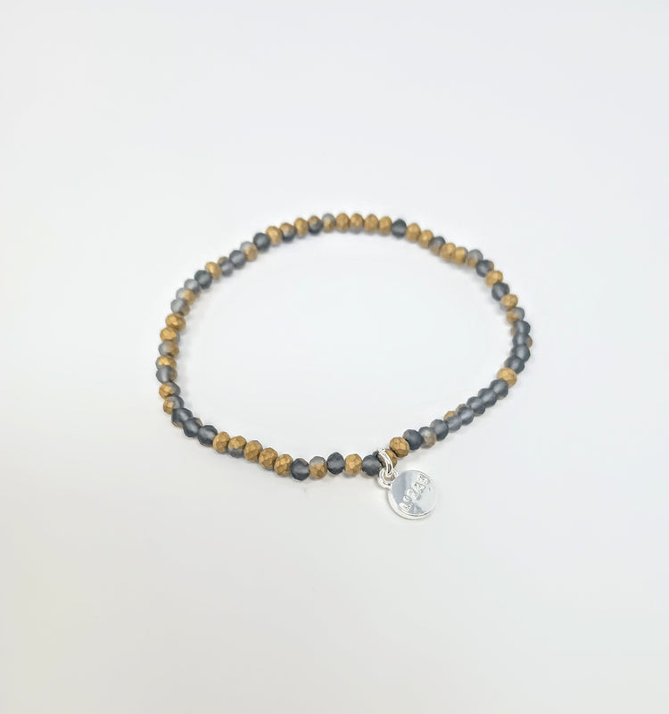 Stretchy beaded bracelet with faceted glass beads in a colorful pattern.