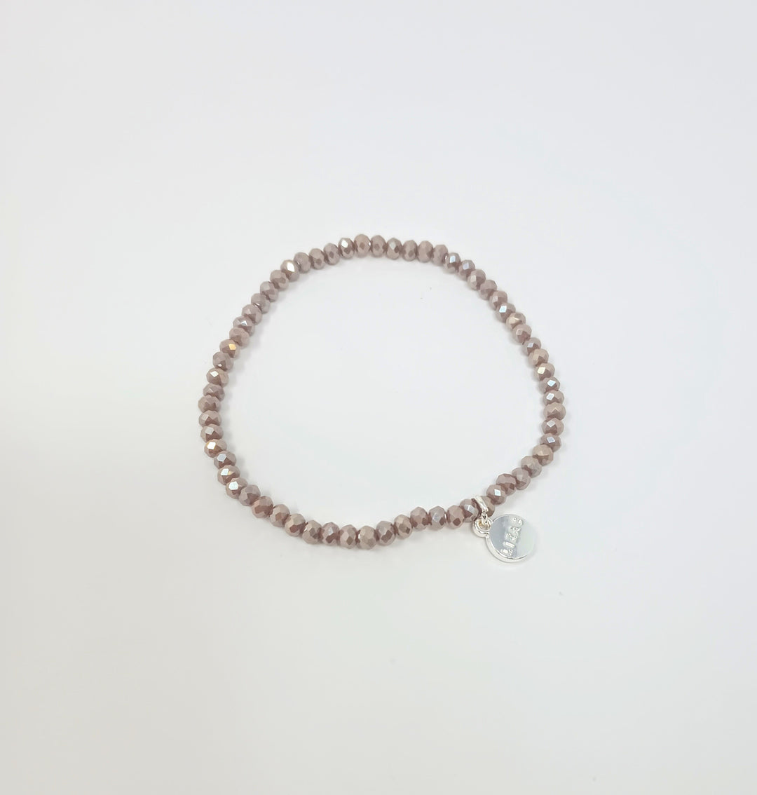 Stretchy bracelet with faceted glass beads in a colorful beaded pattern.