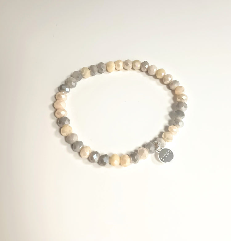 Stretchy bracelet with faceted glass beads in a colorful beaded pattern.