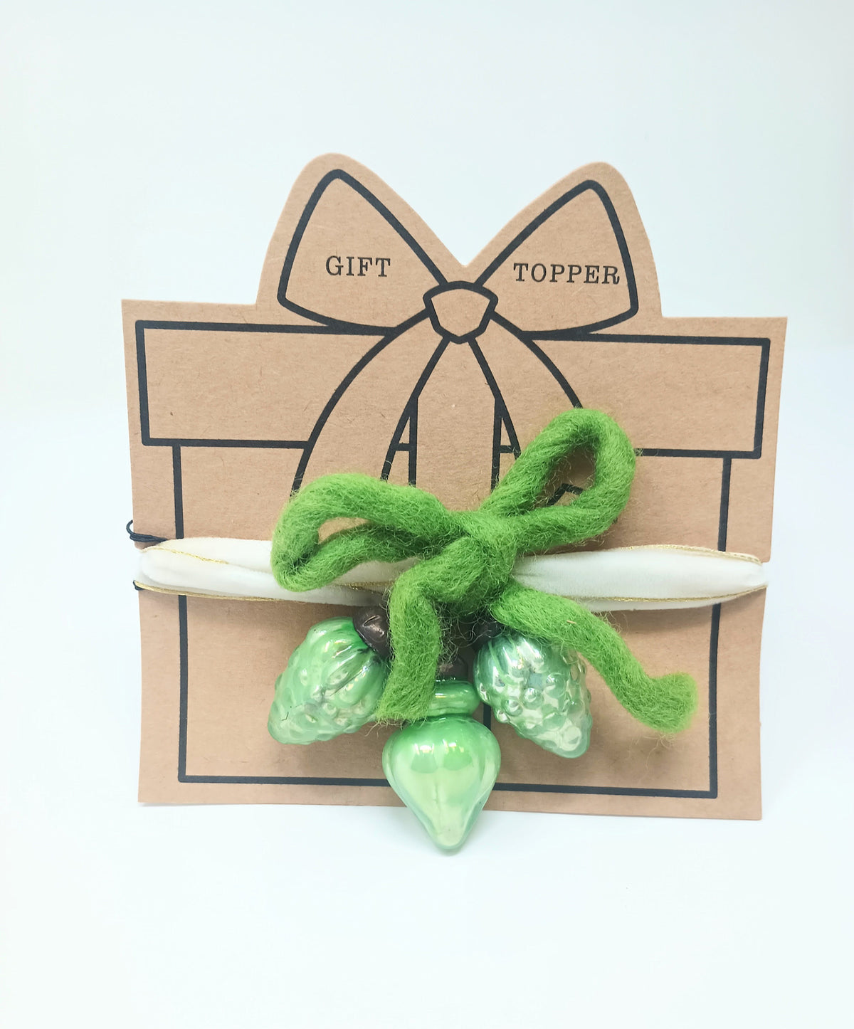 Clear glass ornament gift topper with a festive shape designed as reusable wrapping decoration.