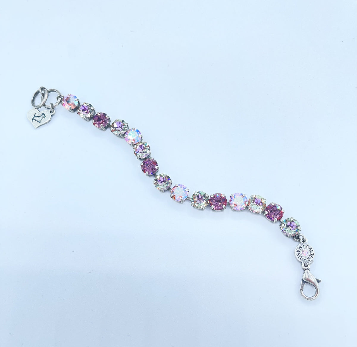 Classic Paris bracelet featuring lavender, lilac, white, and light green stones with an amber tag heart charm.