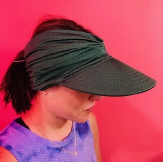 Women's ruched stretchy headband sun visor hat with wide brim and open top design in bright contrasting colors.