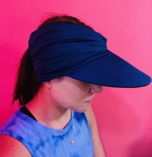 Women's open-top sun visor hat with wide brim in bright contrasting colors and elasticized chinlon fabric.
