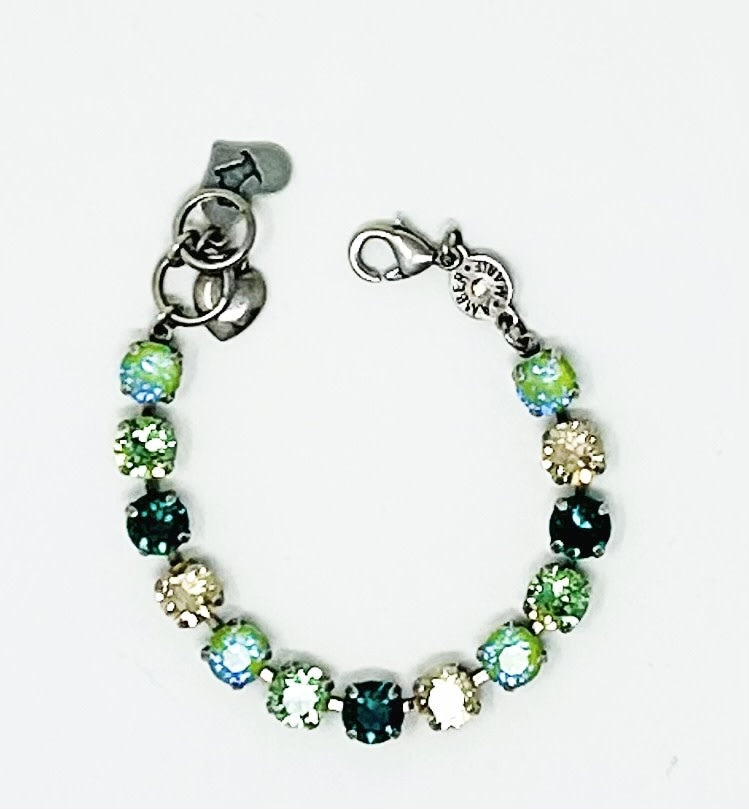 Green collage bracelet with amber tag, crystal accent, Scotty dog heart charm, and adjustable chain.