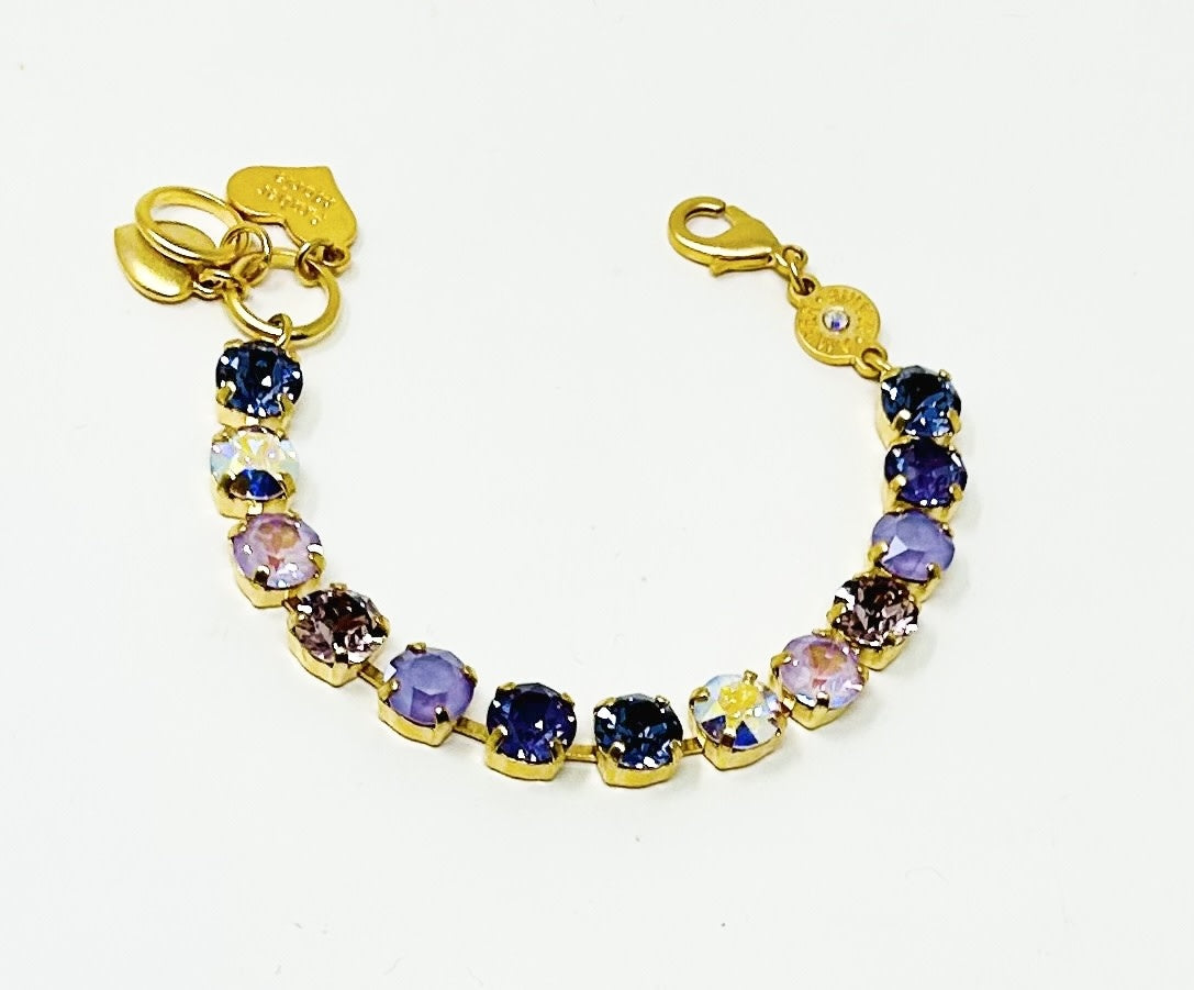Gold bracelet featuring lavender crystals, an amber tag with a crystal, and a Scotty dog heart charm.