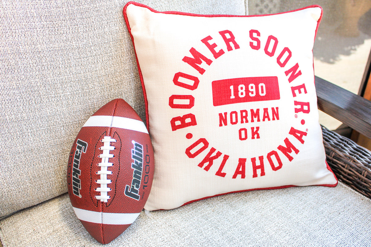 Oklahoma Athletic Circle Pillow with piping in navy blue fabric