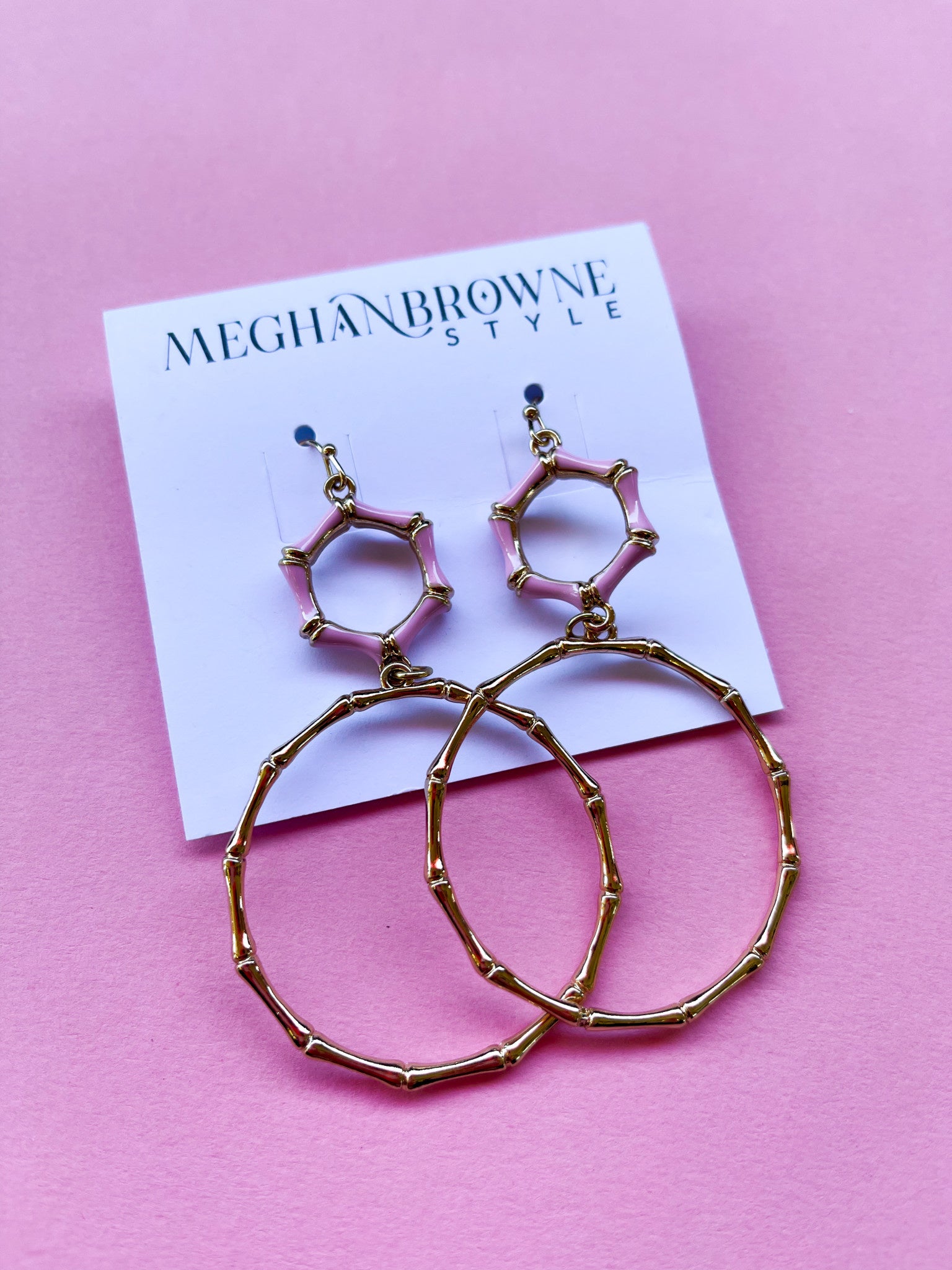 Reba earrings featuring pink enamel hexagonal tops and large gold bamboo-style hoop drops.
