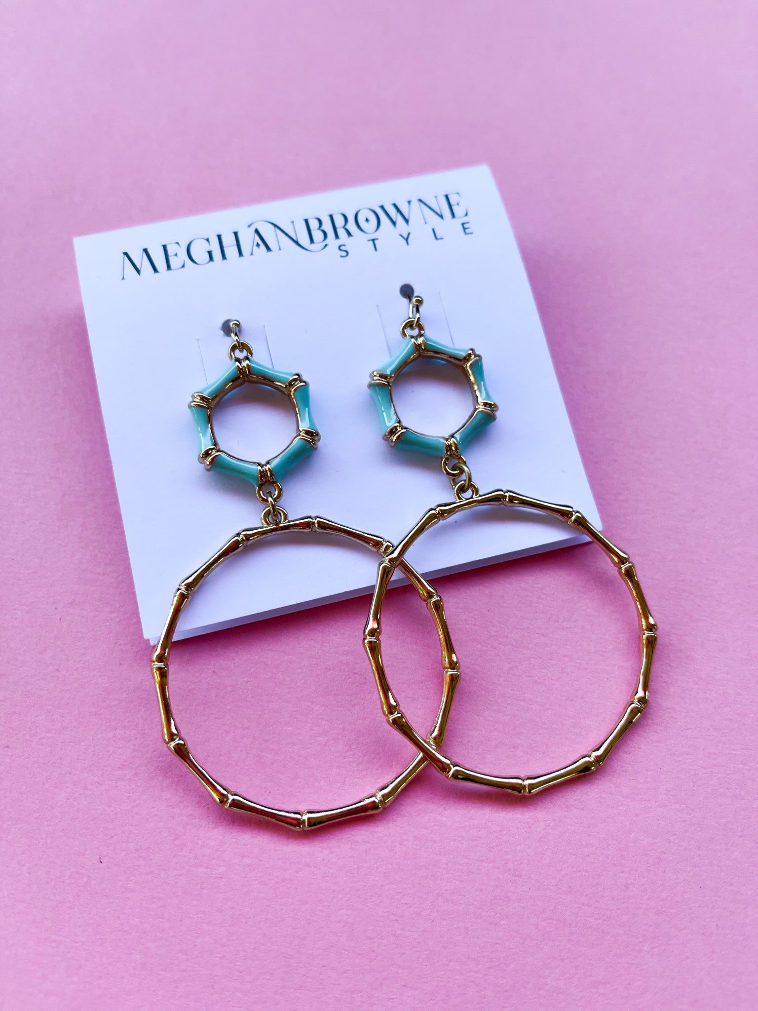 Gold bamboo-style hoop earrings with turquoise hexagonal accents on a Meghan Browne Style card.