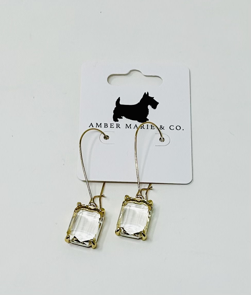 Gold-tone drop earrings featuring clear rectangular crystals on a white Amber Marie & Co. card.