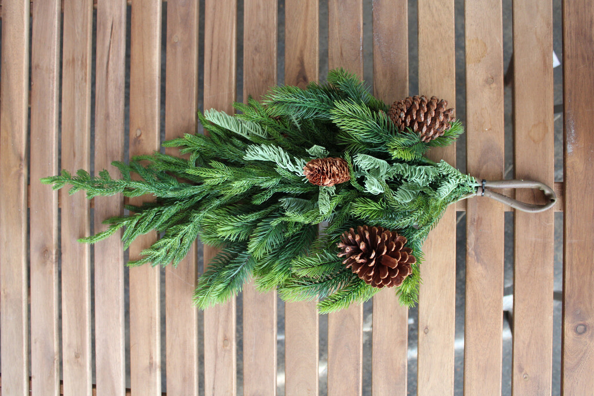 27-inch artificial Norfolk spruce and juniper teardrop swag with three pinecones.