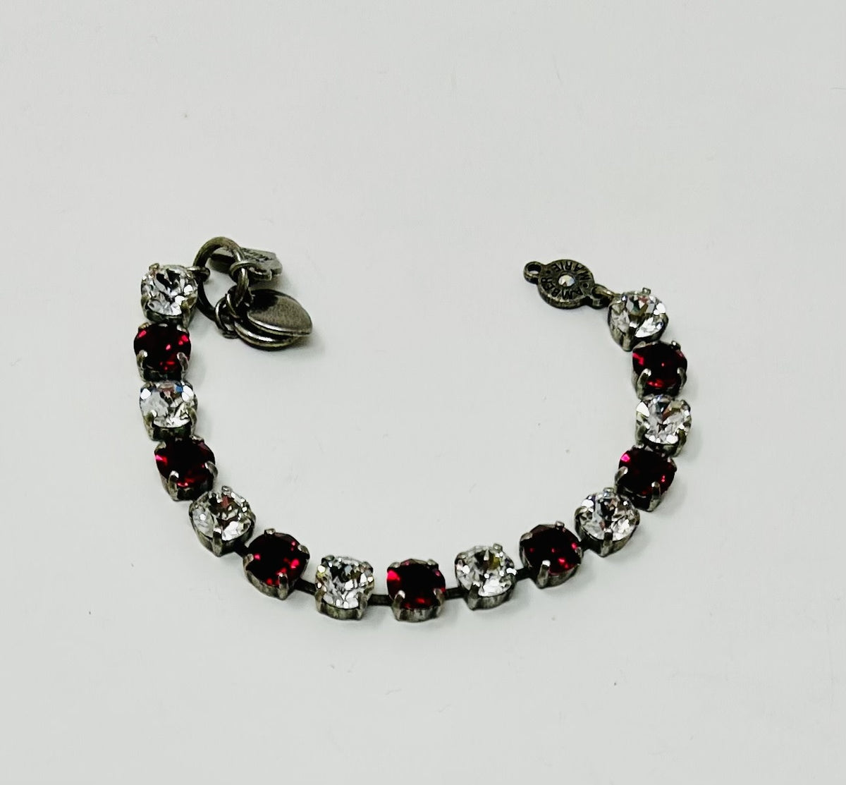 Classic Rome bracelet featuring deep red stones with black accents on a clear band.