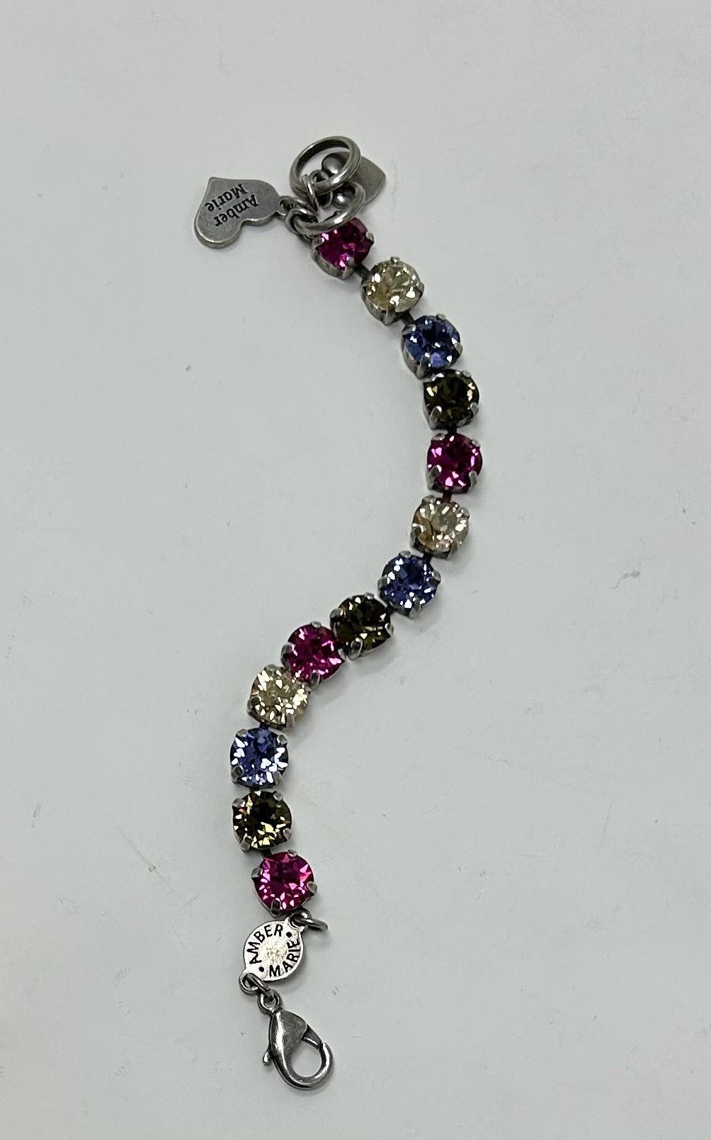 Milan classic bracelet featuring multi-colored round crystals and Amber Marie branded charms.