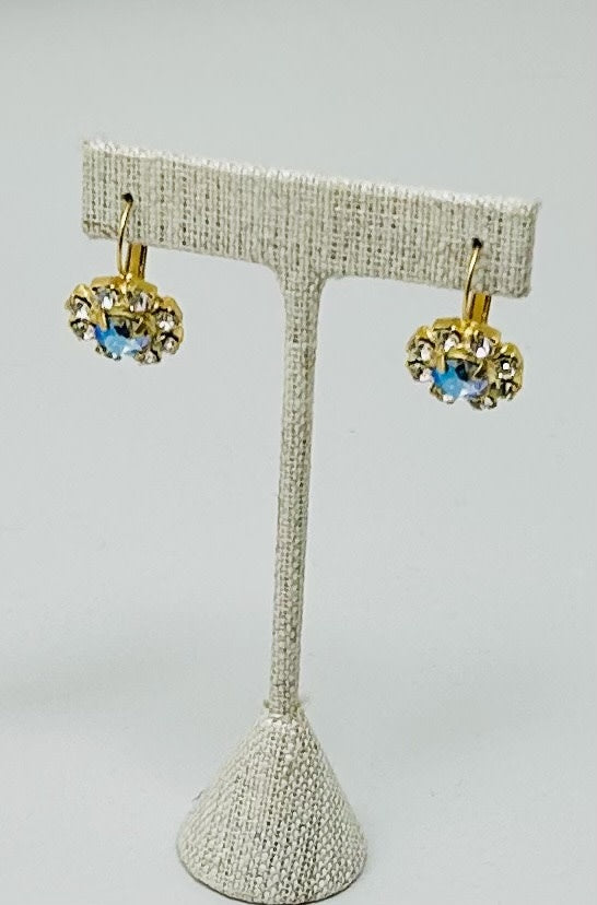 Gold round stud earrings featuring a central stone with pave setting.
