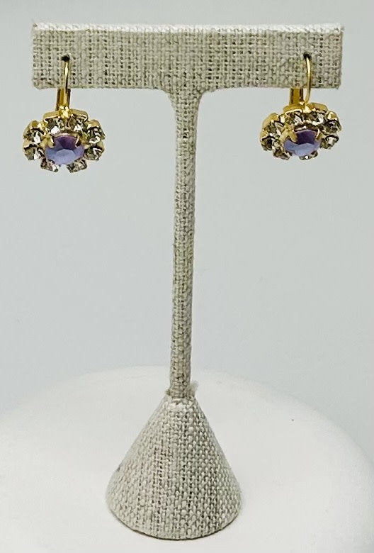 Gold round stud earrings featuring a central stone with pave setting.