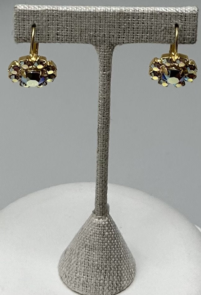 Gold round stud earrings featuring a central stone with pave setting.