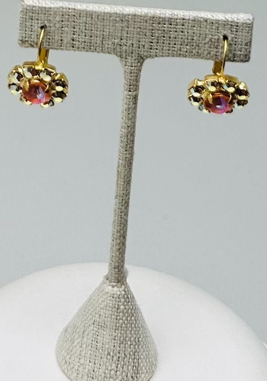 Gold round stud earrings featuring a central stone with pave setting.