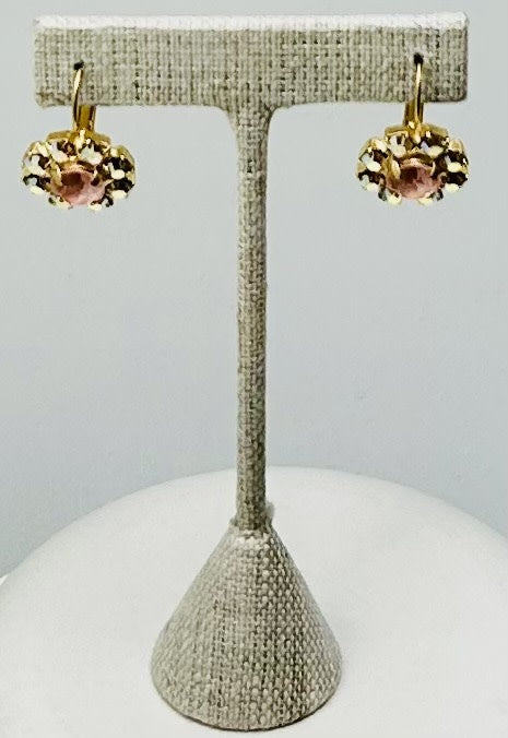 Gold round stud earrings featuring a central stone with pave setting.