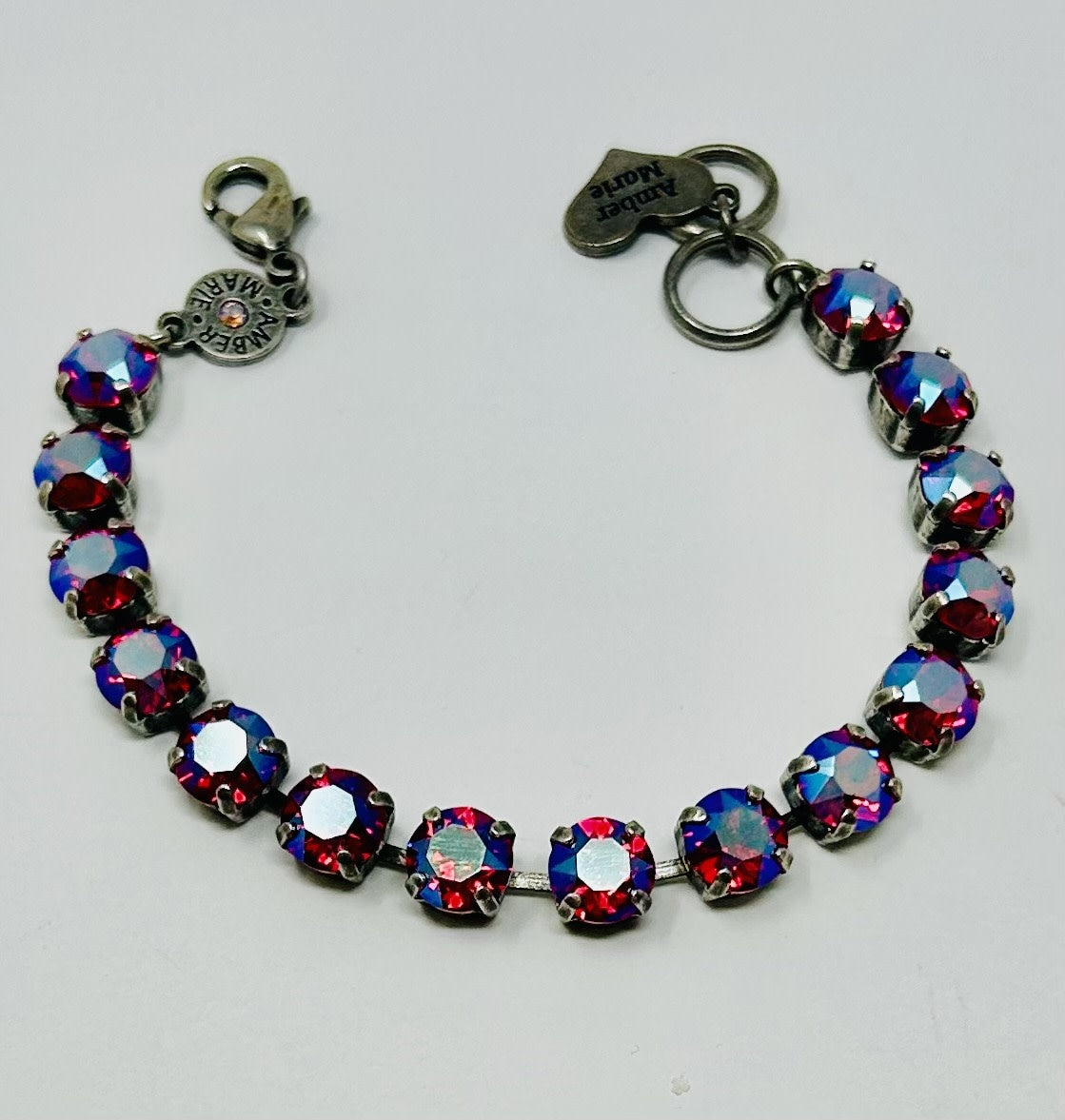 Amber Marie bracelet featuring round, iridescent red crystals set in silver-toned metal links.