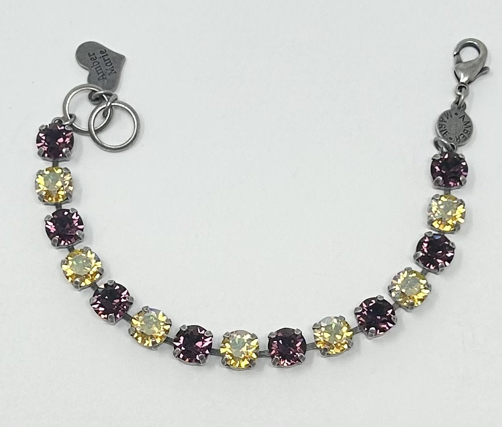 Classic New Orleans bracelet featuring green, yellow, purple stones with an amber tag and Scotty dog heart charm.