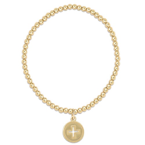 Gold-filled bracelet featuring a signature cross gold disc charm on elastic cord