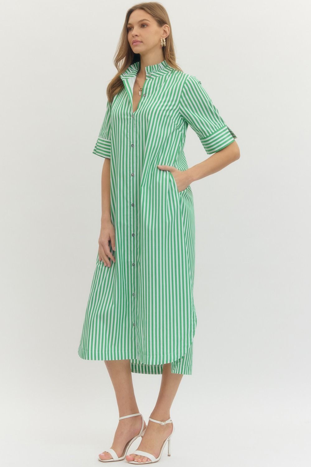 Model wearing a green and white vertical stripe midi dress with 3/4 sleeves and a band collar.