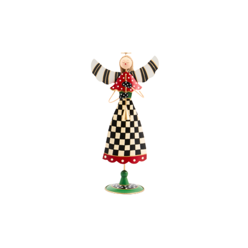 Decorative tin angel with checkered dress, red polka dot cape, and striped wings on a green stand.