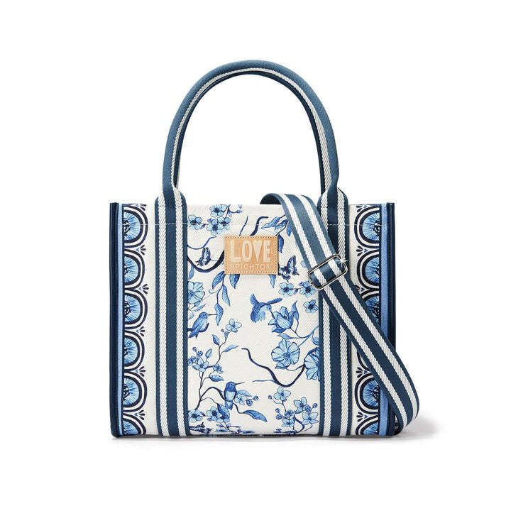 Indigo canvas tote with white background featuring floral songbird art and detachable straps.